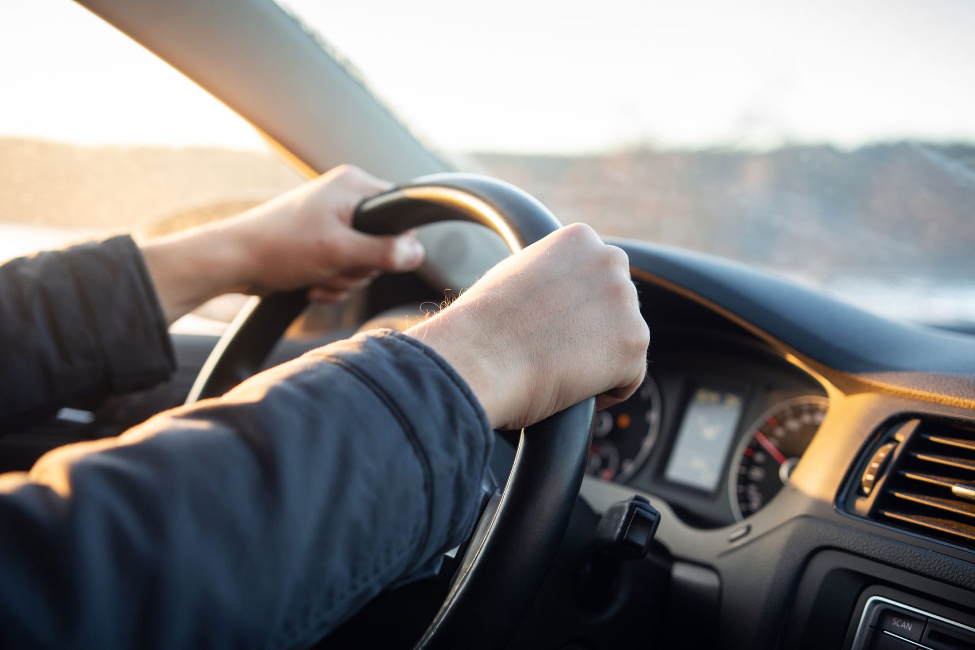 picture of man holding steering wheel with both hands