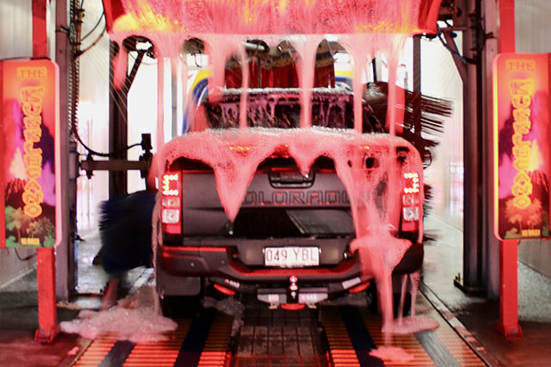 ute driving through tunnel car wash